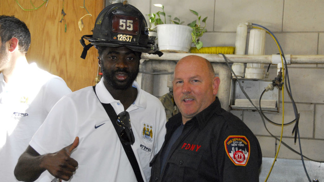 DEFENDERS: Kolo Toure gives the New York Fire Deparment the thumbs up in 2013.