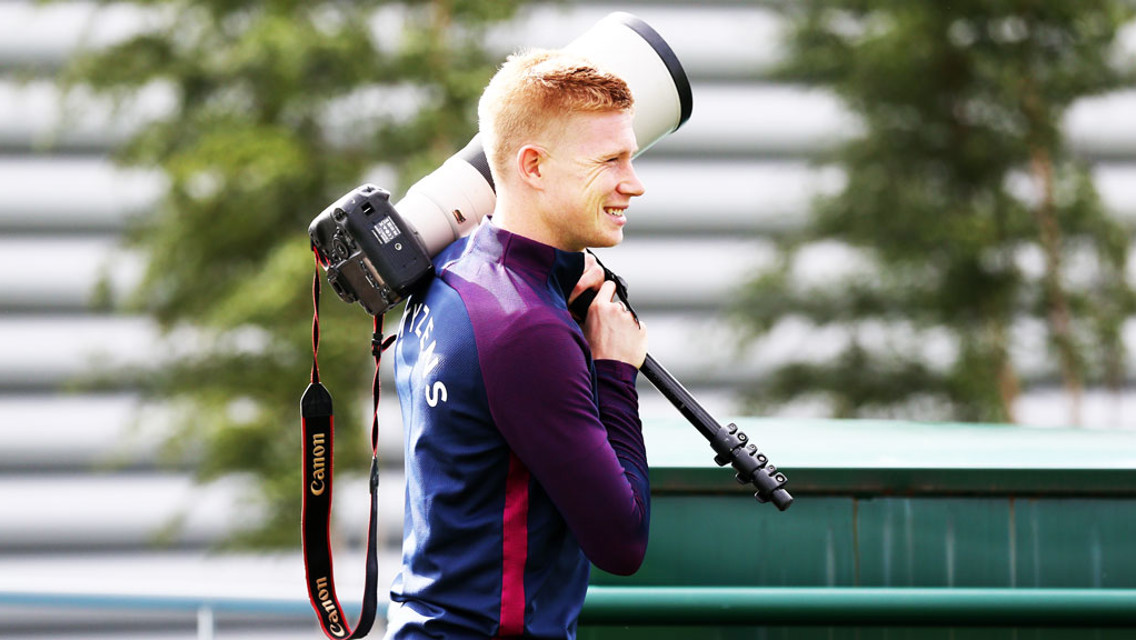 MAY I ASSIST YOU? Kevin De Bruyne helps with the camera gear