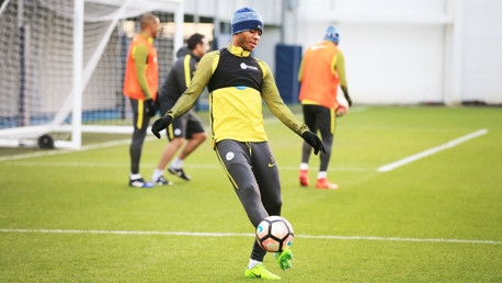 UNDER HIS SPELL: Raheem Sterling gets a touch of the ball as the session moves on