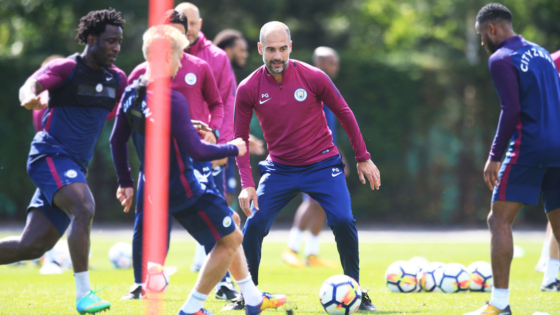 INVOLVED: Pep Guardiola gets stuck in!