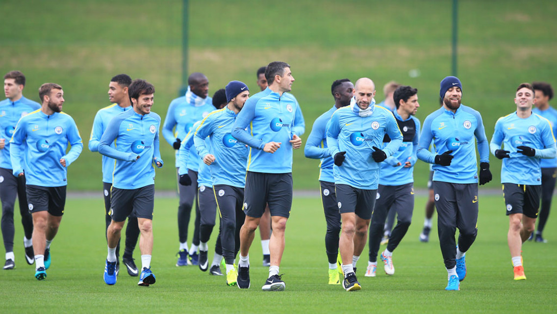 WARM UP: The squad warms up the begin training.