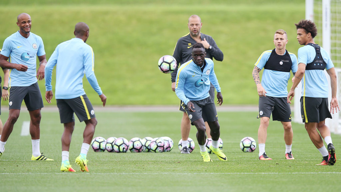 ONE IN FIVE OUT: Sagna chases the ball in the middle