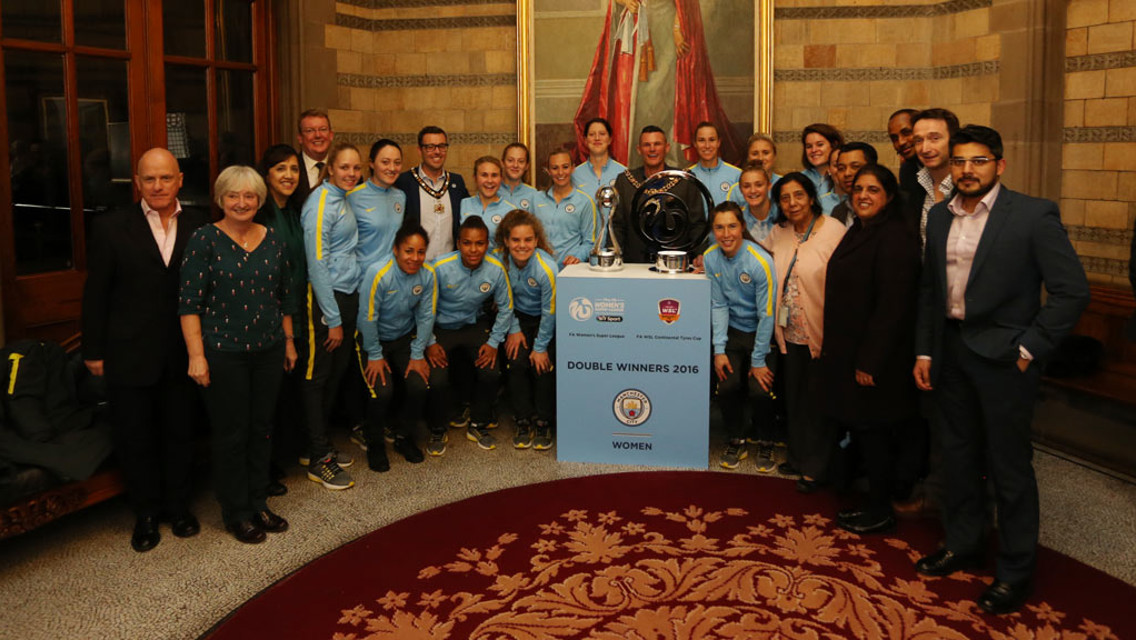 ALL SMILES: Everyone gathers for a snap with City's two trophies