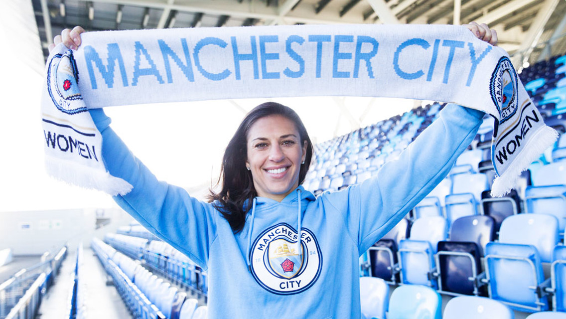 MANCHESTER PRIDE: Carli Lloyd proudly holds the Man City Women scarf aloft