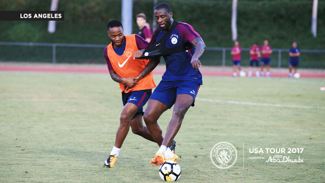 BATTLING FOR THE BALL: Yaya holds off a challenge from Raheem.