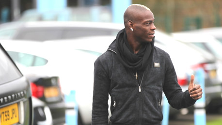 Mario Balotelli is a big fan of Sir Paul McCartney and here he imitates his hero with the single-thumb-aloft as he checks in for work.