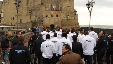 The squad visit a local attraction, flanked by security and police