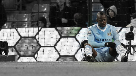 A missed chance is shrugged off but Mario's more concerned about the whether his socks look the part or not.