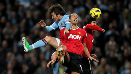 Diminutive David belies his size to let Rio Ferdinand know he's about.