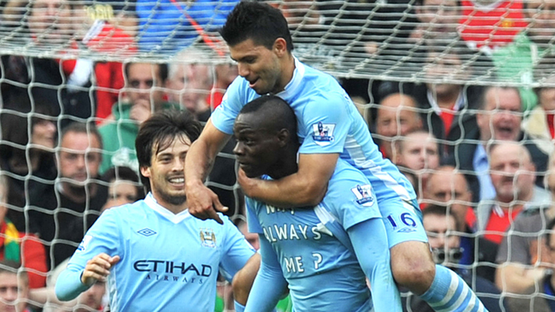  The team celebrate Mario's second as the Italian reveals his famous t-shirt!