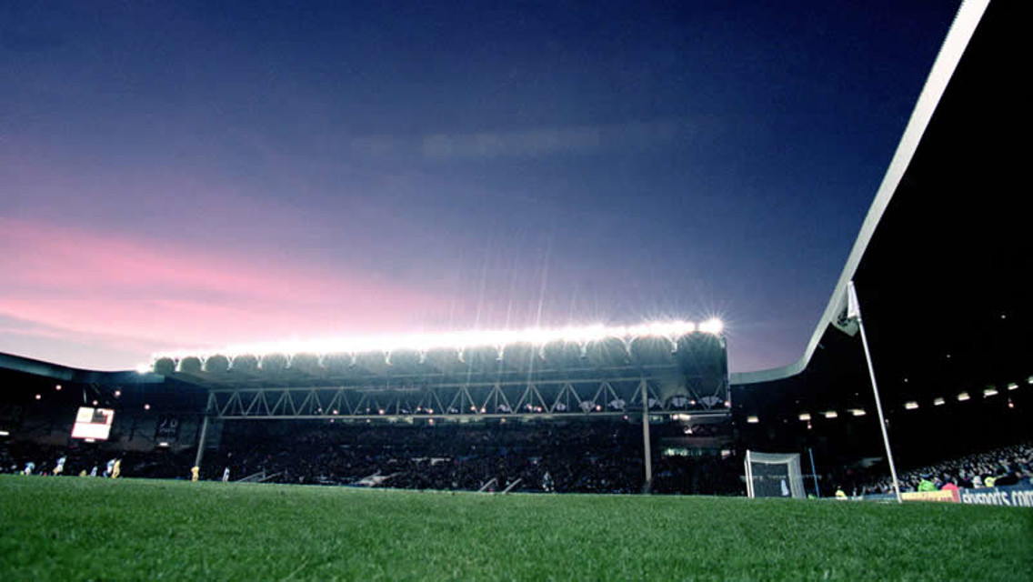 An atmospheric pitch-level view of the old ground by night.