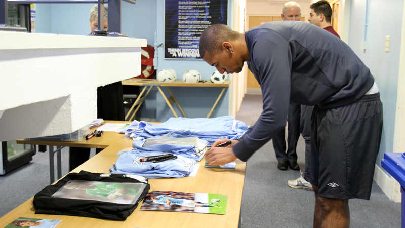 Jerome Signing shirts.