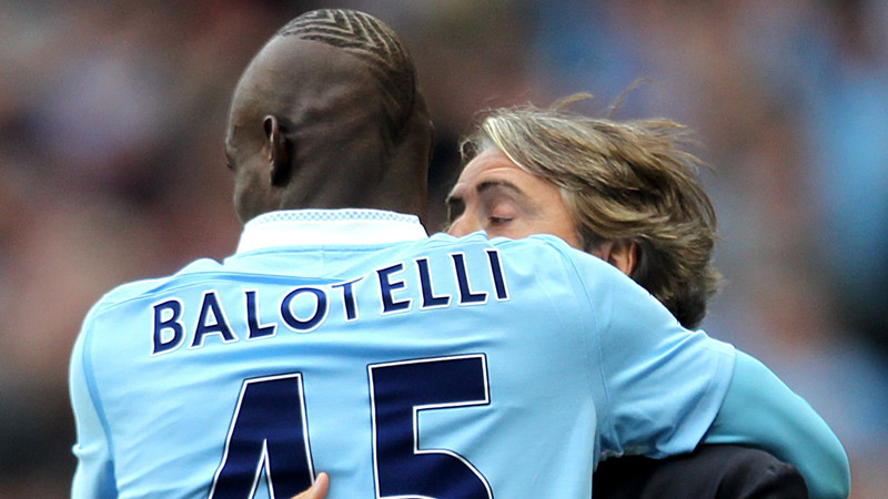 Mario Balotelli hugs Roberto Mancini