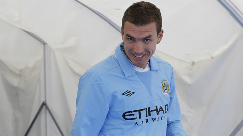 Edin spots the camera as he goes out to the bench