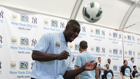   Micah shows the kids how it's done with a strong head on the ball