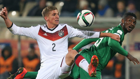 Germany's Grischa Proemel, left, fights for the ball against Nigeria's Success Isaac