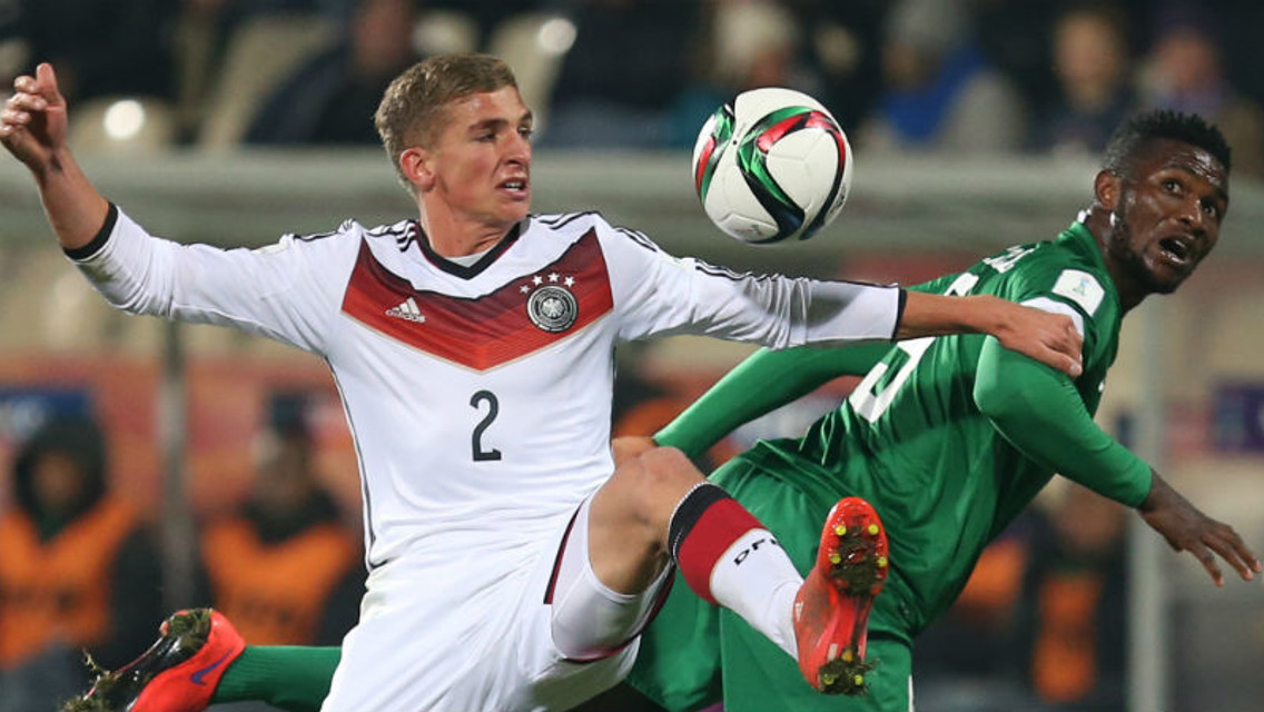 Germany's Grischa Proemel, left, fights for the ball against Nigeria's Success Isaac