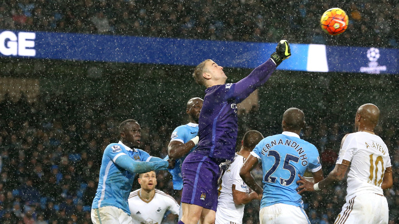 Joe Hart punches the ball clear