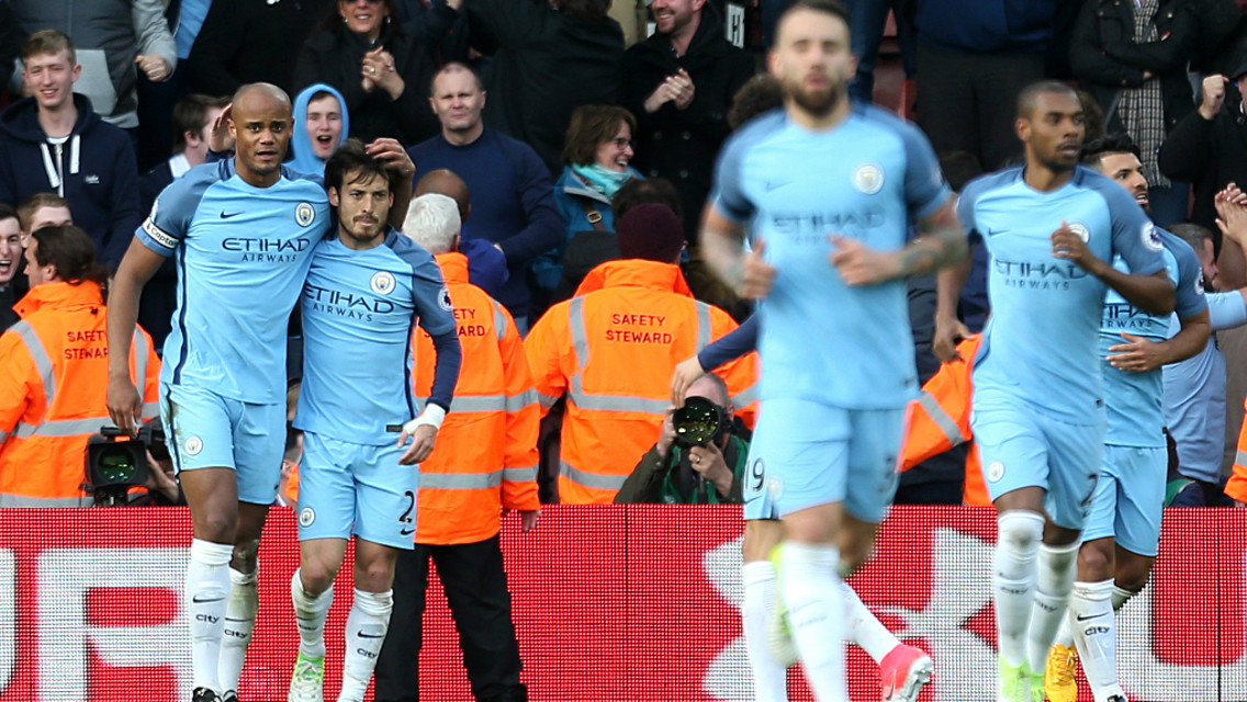 DELIGHT: Silva congratulates the City captain after breaking the deadlock with a fine header. 