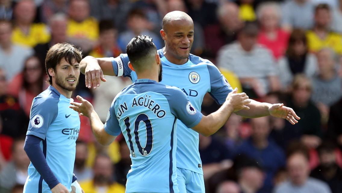 SMILES ALL ROUND: Kompnay and Aguero embrace to celebrate City's opener.