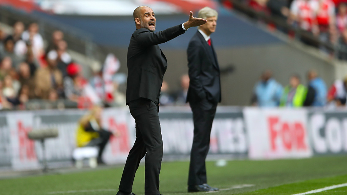 GIVING ORDERS: Pep and Wenger on the touchline.