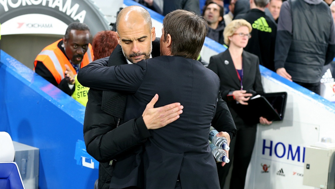 CALM BEFORE THE STORM: Pep and Conte exchange a pre-match embrace.