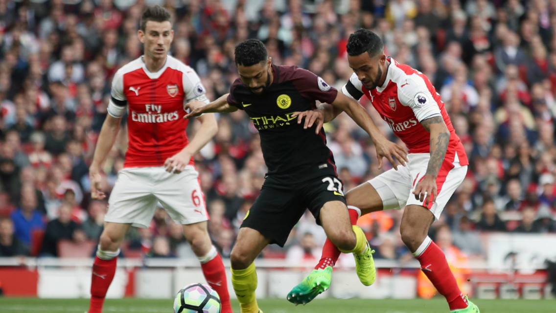 FAMILIAR FACES: Clichy battles with former team mate Walcott.
