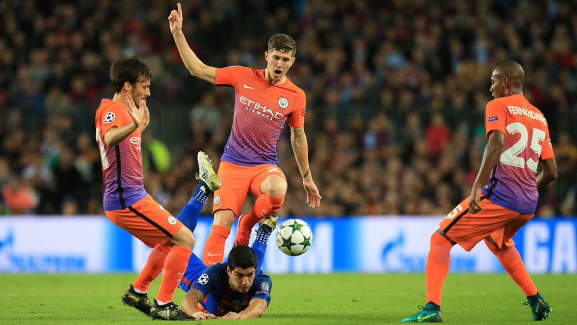 SURROUNDED: Manchester-City's trio David Silva, John Stones and Fernandinho in defence