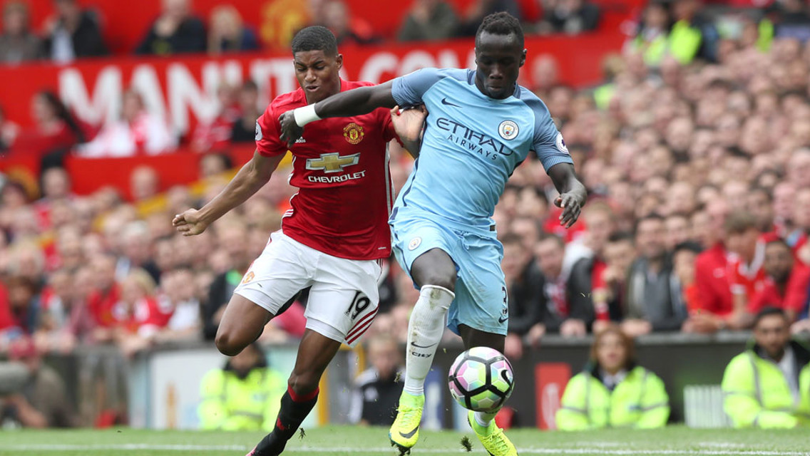 RIGHT ON: Bacary Sagna shields the ball from Marcus Rashford