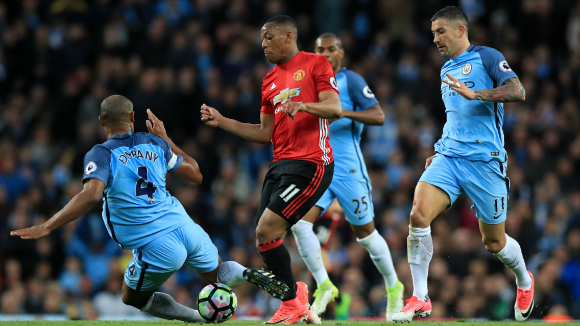 SOLID CHALLENGE: The skipper wins the ball from Anthony Martial with a well-timed tackle.