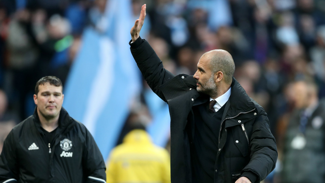 SHOWING THE LOVE: Pep waves to the City faithful as he makes his way to the dugouts.
