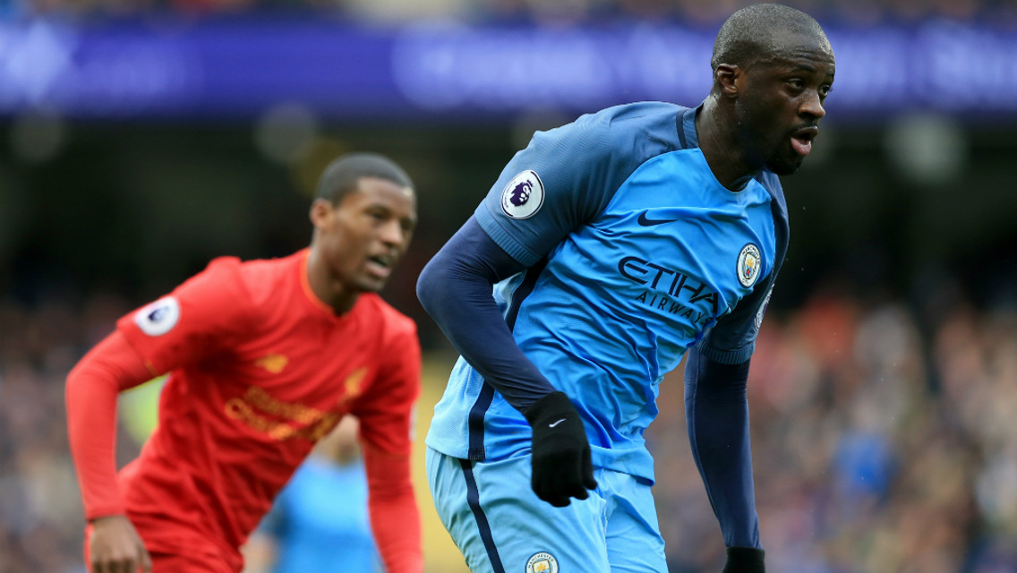 MIDFIELD BATTLE: Toure looks to break away from Georginio Wijnaldum