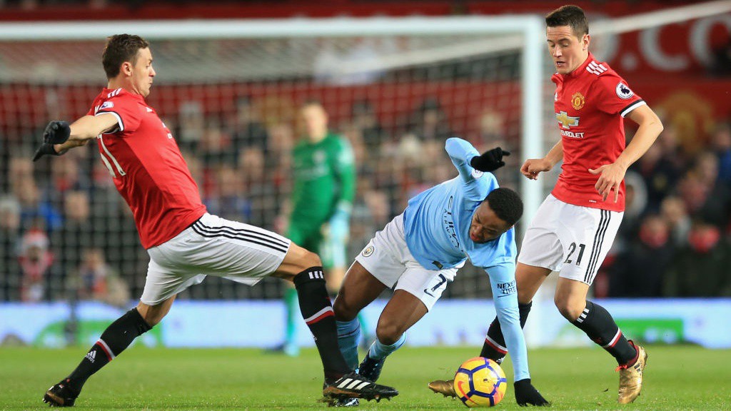 SLALOM: Raheem Sterling dances his way between a pair of tackles in the first half. 