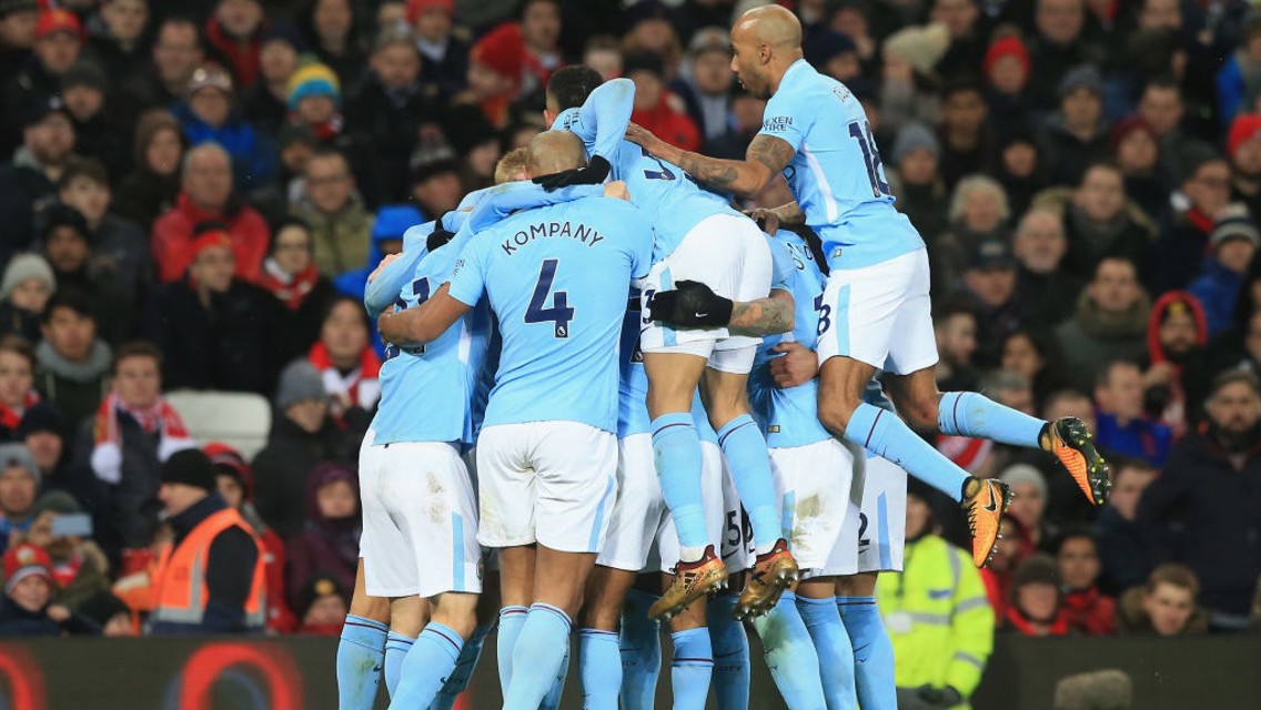 BREAKTHROUGH: City pile on David Silva after his volley opened the scoring.