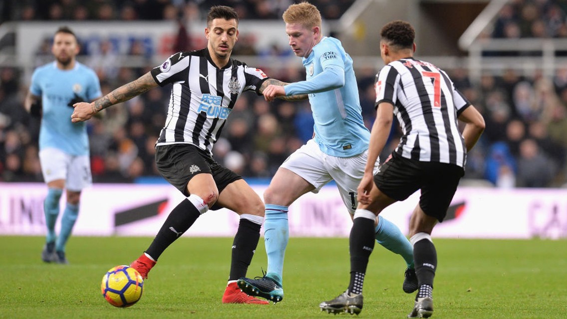 SURROUNDED: Kevin De Bruyne negotiates his way past Newcastle's Jacob Murphy and Joselu.