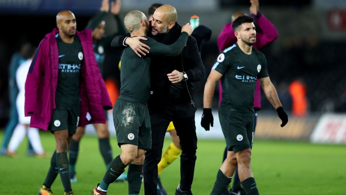 HISTORY BOYS: Pep Guardiola and David Silva celebrate City's record-breaking 15th consecutive league win.