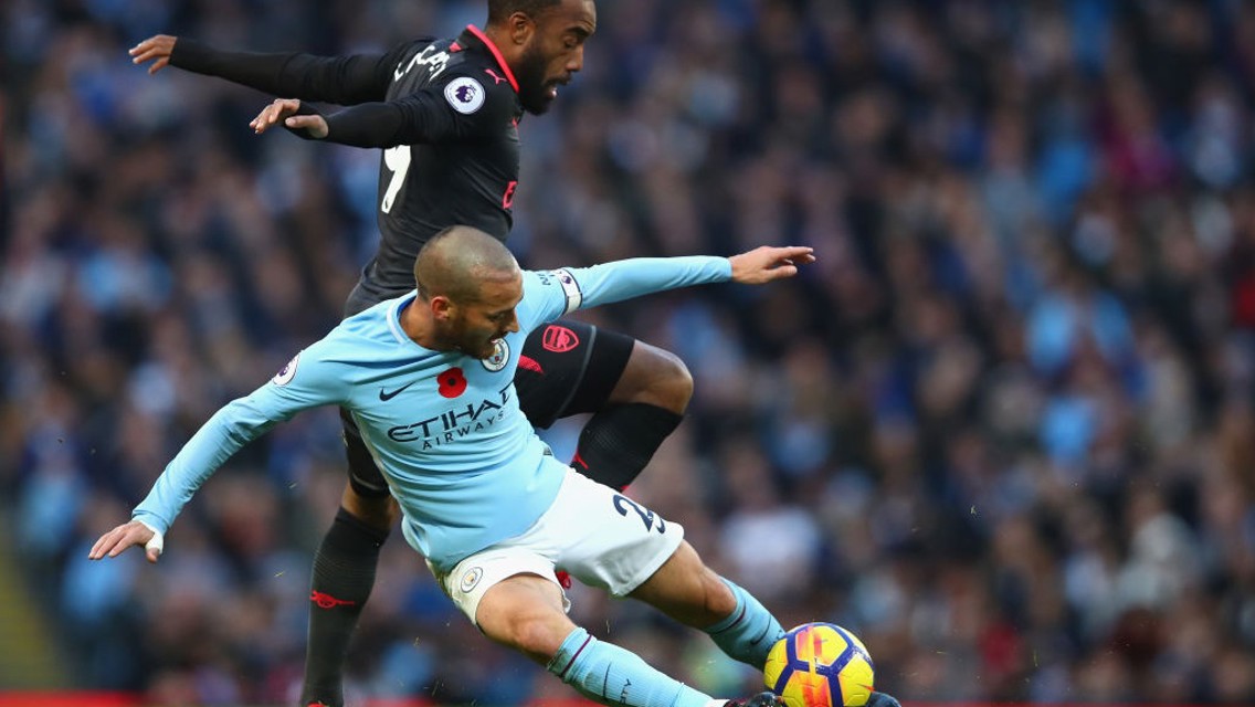 LEADING BY EXAMPLE: Captain David Silva wins the ball from Alexandre Lacazette. 