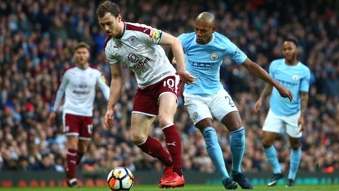 BATTLING: Fernandinho puts Ashley Barnes under pressure.