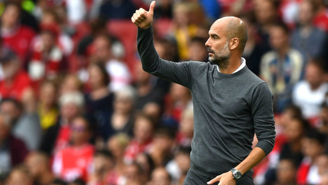 CITY V ARSENAL: Pep gives his players the thumbs up in the game at the Emirates earlier this season