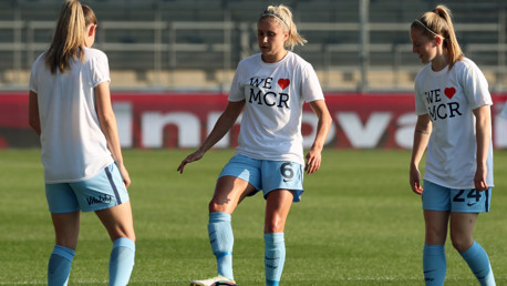 CITY UNITED: Steph Houghton warms up in a tribute shirt along with fellow team-mates 