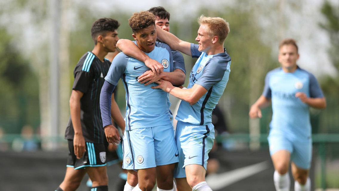 STRIKE: Sancho is mauled by his teammates after scoring City's equaliser. Photo by Matthew Ashton.