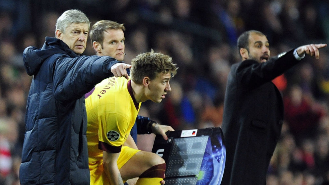 OVER THERE: Wenger and Guardiola dictate to their sides during a previous meeting