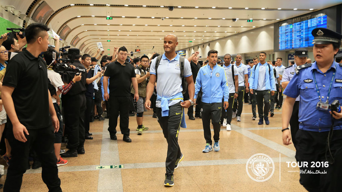 TOUCHDOWN: Vincent Kompany leads the way at Beijing International Airport.