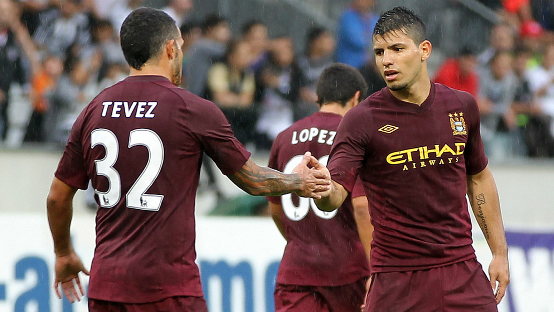 CELEBRATIONS: Carlos Tevez congratulates Sergio Aguero on his opener
