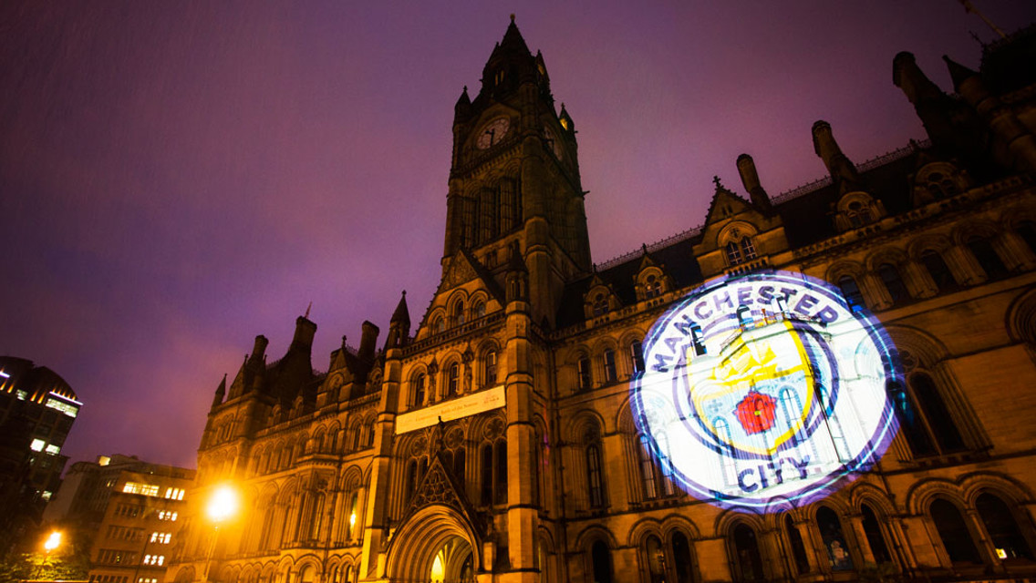 IT BEGINS: The new Badge projected onto Manchester Town Hall on Thursday night