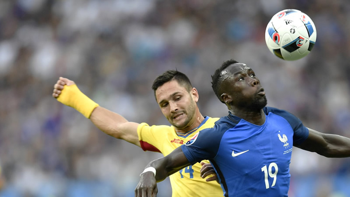BACS TO THE WALL: Sagna in action against Romania