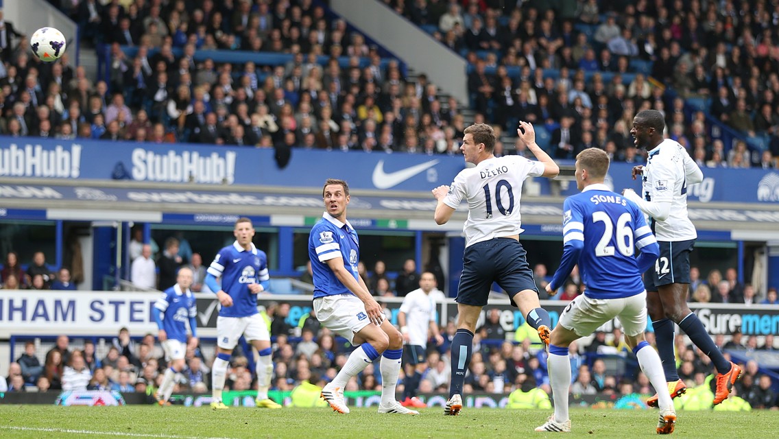 FLYING HIGH: Edin Dzeko jumps up up and away for the goal