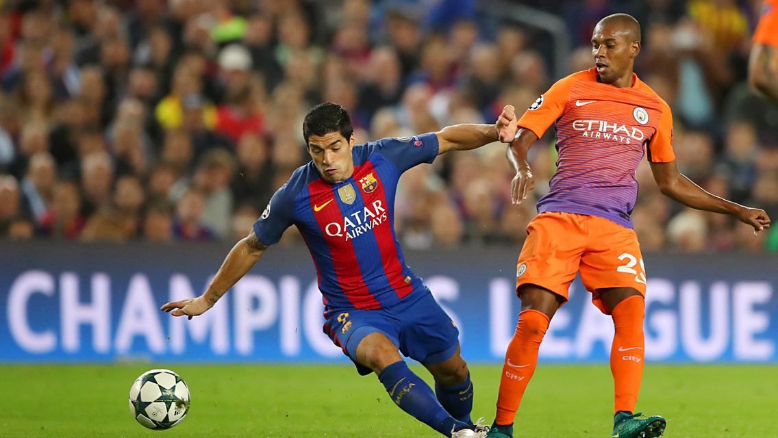 FALLING OVER: In an attempt to run on the ball, Suarez falls over under Fernandinho's pressure