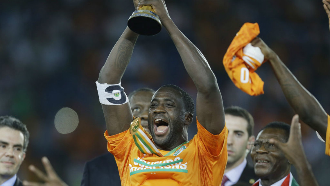 AT LONG LAST: Yaya holds the AFCON trophy aloft after finally getting his hands on it