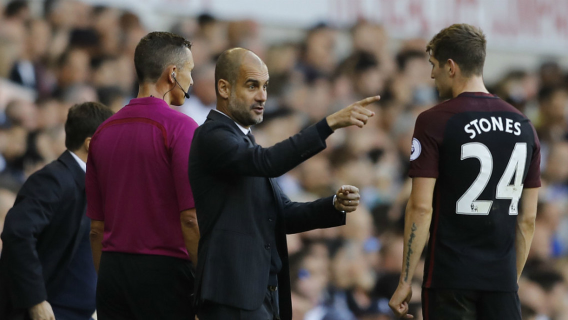 LEARNING: John Stones receives some instructions from the boss.